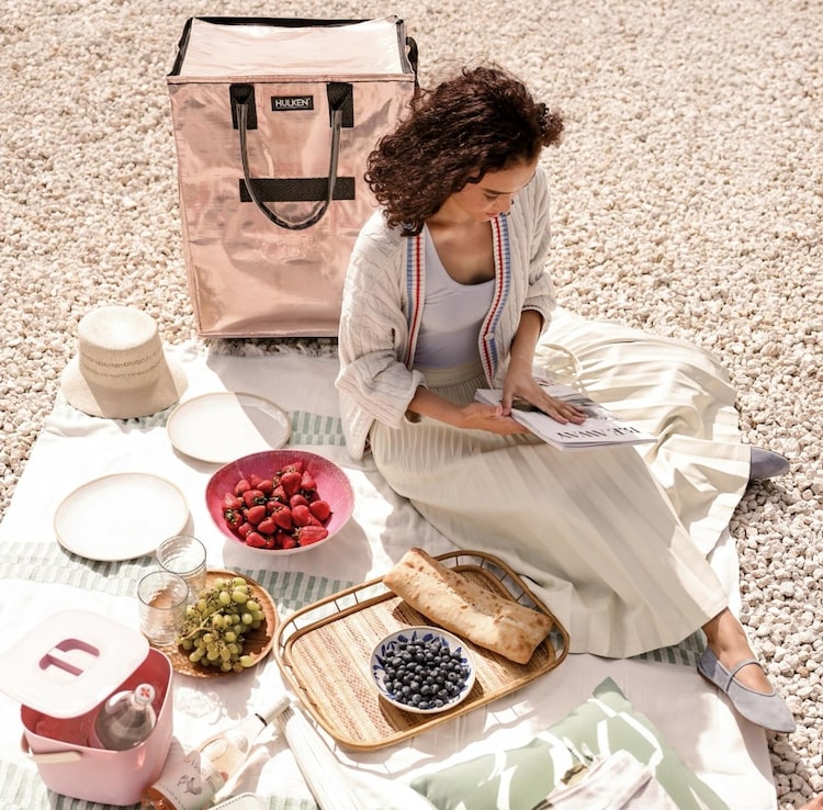 A picnic: plates with food and a tote bag